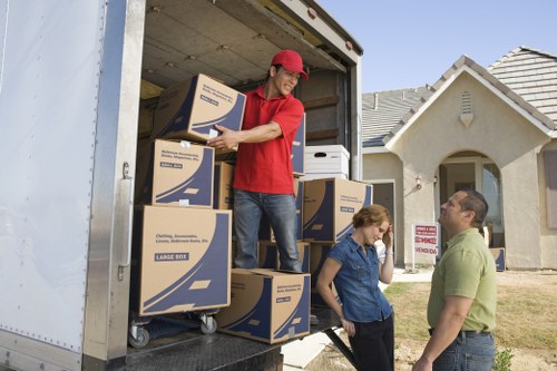 Professional movers loading household items into a van in Camden